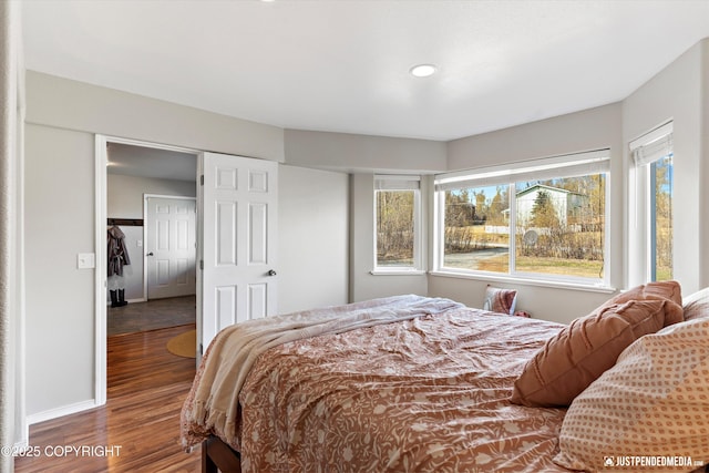 bedroom with baseboards, recessed lighting, and wood finished floors