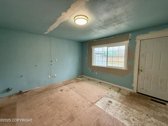 empty room featuring a textured ceiling and visible vents