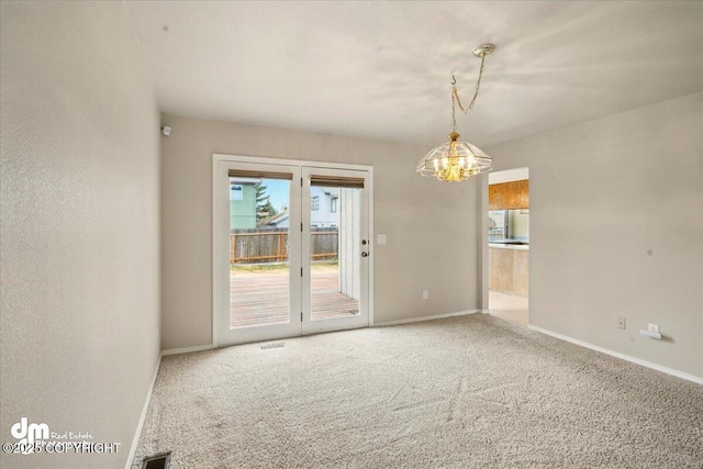 12100 Woodway Cir, Anchorage, AK 99516 - spare room featuring a chandelier, carpet floors, and baseboards