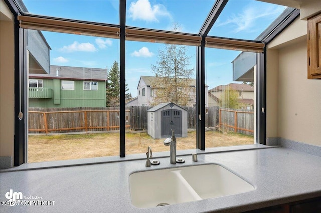 12100 Woodway Cir, Anchorage, AK 99516 - kitchen featuring healthy amount of natural light, a sink, and a wall of windows