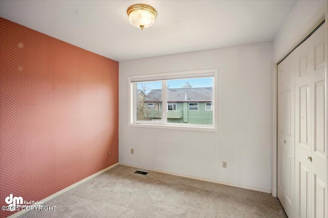 12100 Woodway Cir, Anchorage, AK 99516 - unfurnished bedroom featuring a closet, carpet flooring, and baseboards
