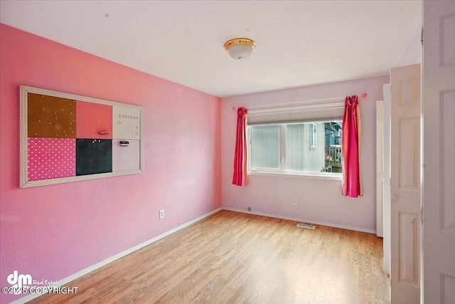 12100 Woodway Cir, Anchorage, AK 99516 - spare room featuring wood finished floors and baseboards