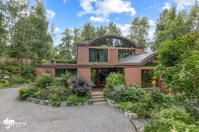 view of front of house featuring fence