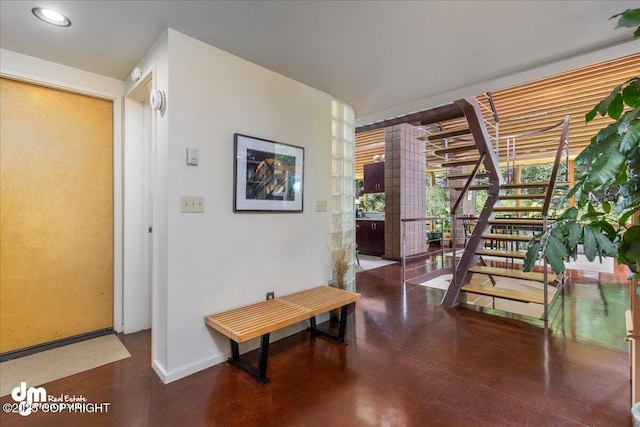 hallway with recessed lighting, baseboards, and decorative columns