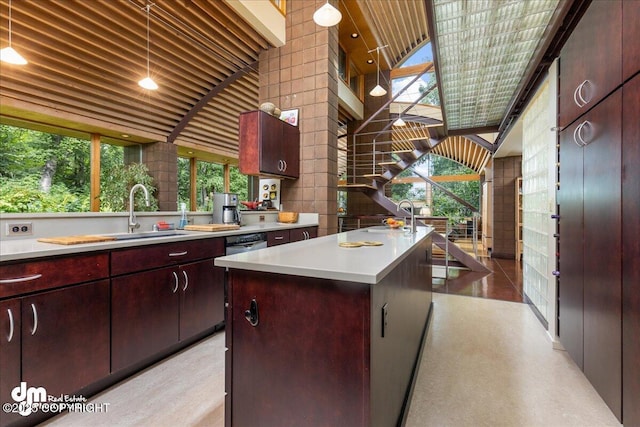 kitchen featuring a center island, a sink, plenty of natural light, and light countertops