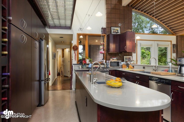 kitchen featuring light countertops, a sink, lofted ceiling, and stainless steel appliances