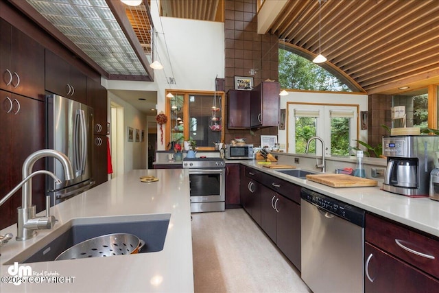 kitchen featuring a sink, appliances with stainless steel finishes, tasteful backsplash, and light countertops