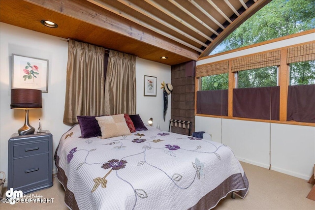 bedroom with carpet flooring and lofted ceiling