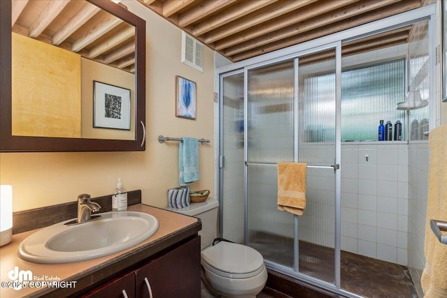 bathroom featuring vanity, a stall shower, and visible vents