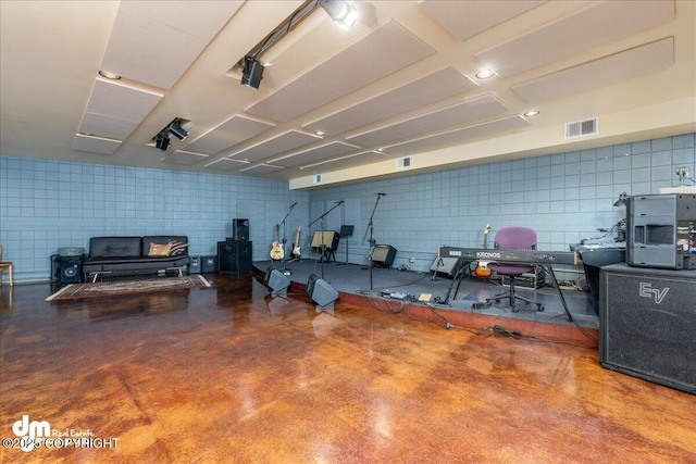 misc room with visible vents and finished concrete flooring