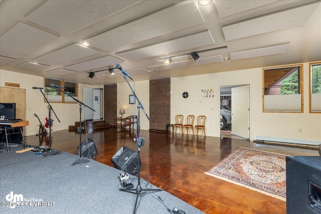 exercise area featuring ornate columns and a baseboard radiator