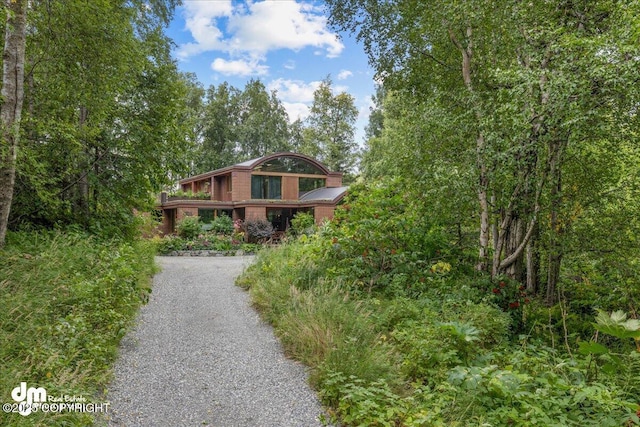rustic home featuring driveway