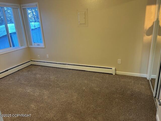 carpeted spare room with baseboards