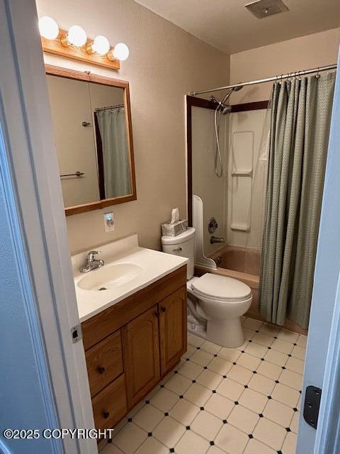 bathroom featuring vanity, shower / bath combo, tile patterned floors, and toilet