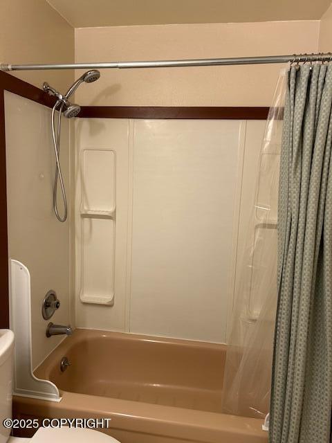 bathroom with toilet and shower / bath combination with curtain
