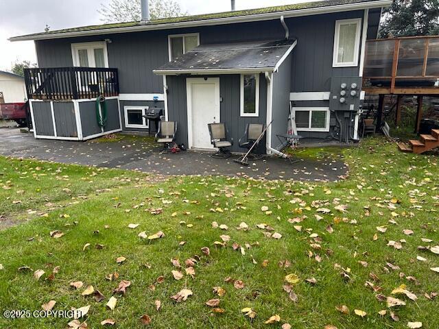 back of property featuring a lawn and a patio area