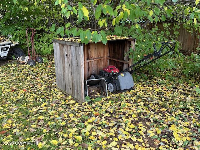 view of outbuilding featuring fence