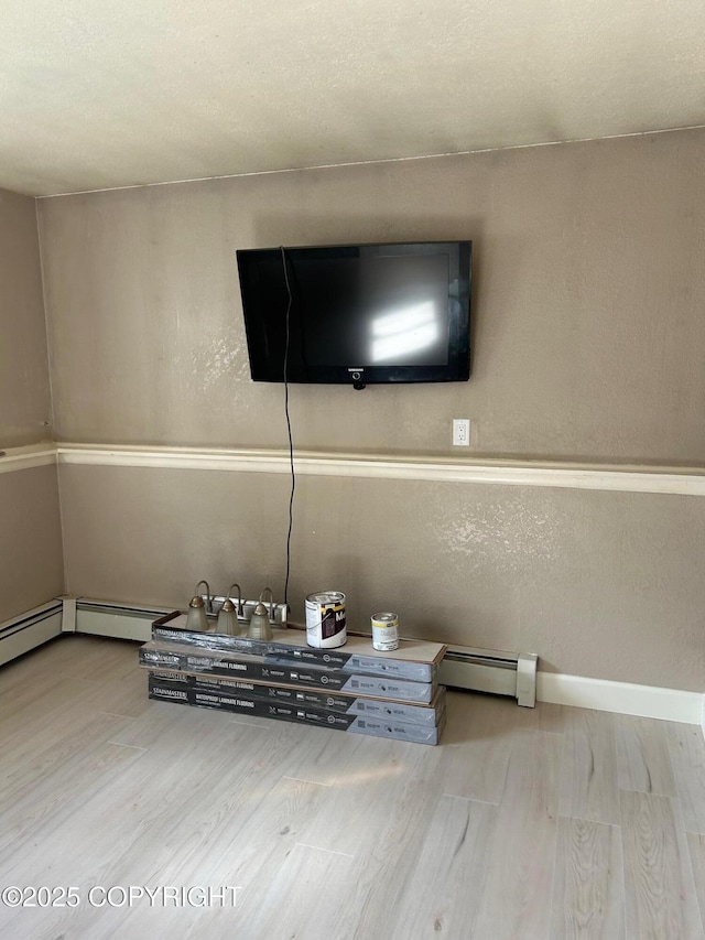 detailed view of wood finished floors and baseboard heating