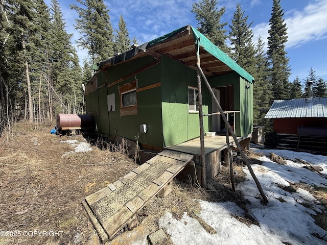 view of side of home with heating fuel