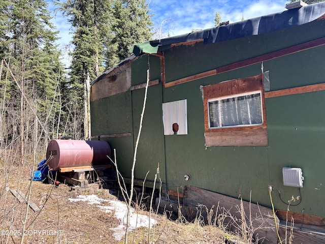 view of side of property featuring heating fuel
