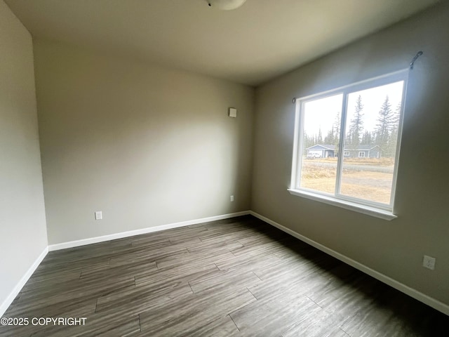 49045 Gemini Ct, Soldotna, AK 99669 - empty room featuring baseboards and dark wood-style flooring