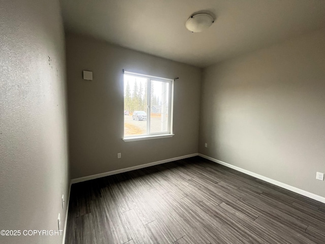 49045 Gemini Ct, Soldotna, AK 99669 - empty room featuring dark wood-style flooring and baseboards