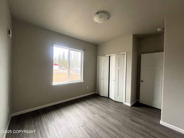 49045 Gemini Ct, Soldotna, AK 99669 - unfurnished bedroom featuring baseboards, wood finished floors, and a closet