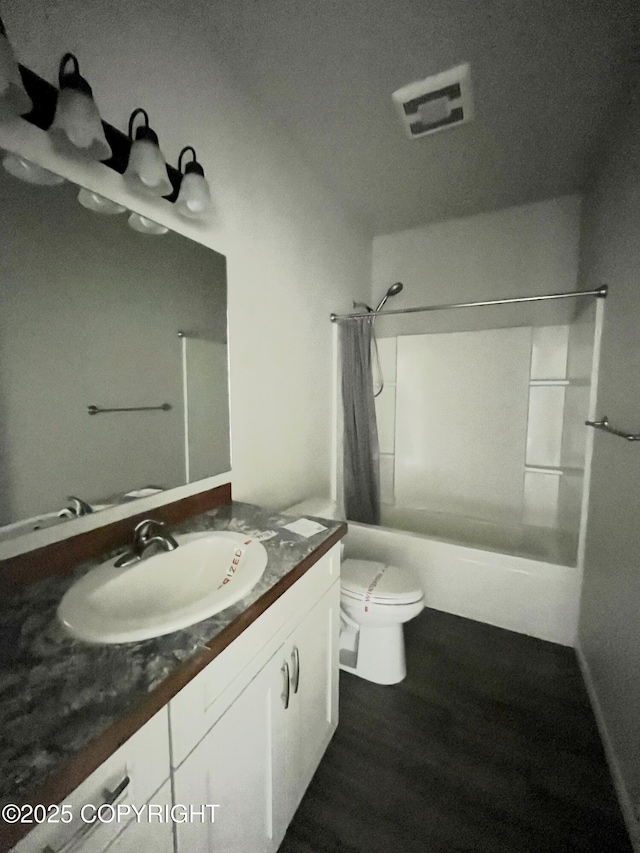 49045 Gemini Ct, Soldotna, AK 99669 - full bathroom featuring vanity, toilet, wood finished floors, shower / tub combo, and visible vents