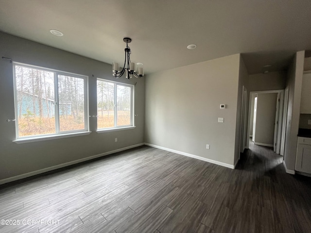49045 Gemini Ct, Soldotna, AK 99669 - unfurnished dining area with baseboards, a chandelier, and dark wood-style floors