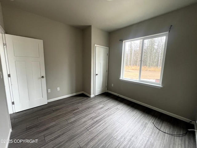 49045 Gemini Ct, Soldotna, AK 99669 - unfurnished bedroom with baseboards and dark wood-style floors