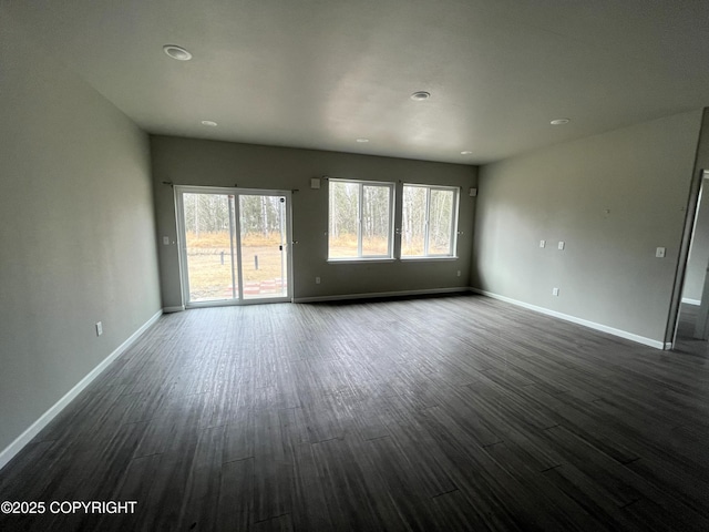 49045 Gemini Ct, Soldotna, AK 99669 - unfurnished living room featuring recessed lighting, baseboards, and dark wood-style floors
