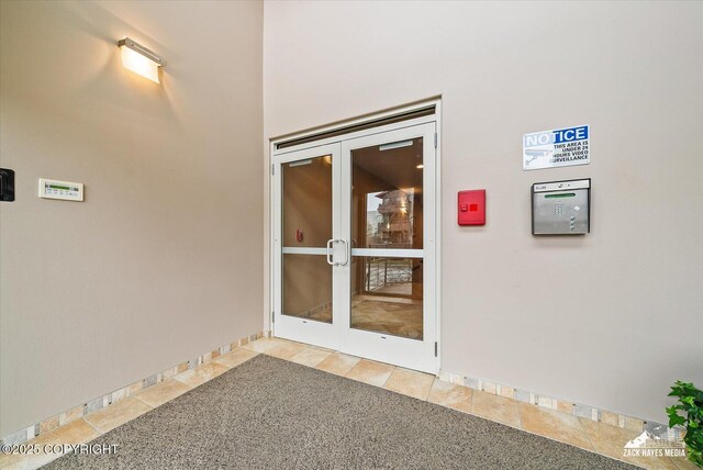 222 E 7th Ave # 106, Anchorage, AK 99501 - property entrance with stucco siding and french doors