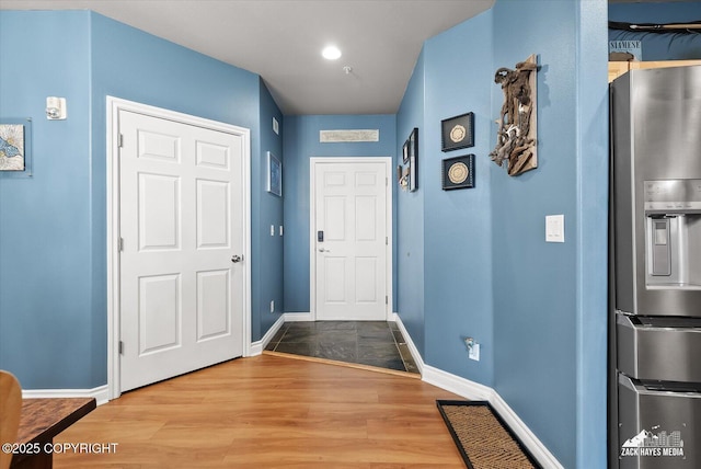 222 E 7th Ave # 106, Anchorage, AK 99501 - entryway featuring baseboards and wood finished floors