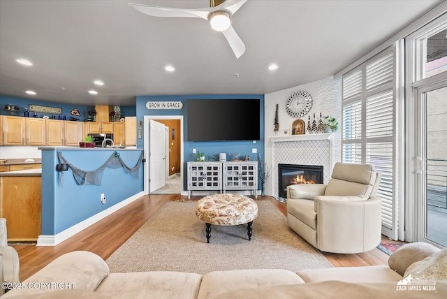 222 E 7th Ave # 106, Anchorage, AK 99501 - living area featuring light wood-type flooring, a ceiling fan, recessed lighting, and a fireplace