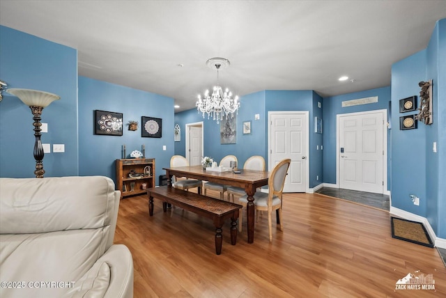 222 E 7th Ave # 106, Anchorage, AK 99501 - dining space featuring light wood-style floors, baseboards, recessed lighting, and a chandelier