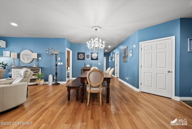 222 E 7th Ave # 106, Anchorage, AK 99501 - dining space featuring an inviting chandelier, baseboards, recessed lighting, an AC wall unit, and light wood-type flooring