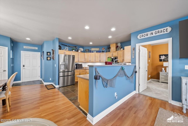 222 E 7th Ave # 106, Anchorage, AK 99501 - kitchen with wood finished floors, recessed lighting, appliances with stainless steel finishes, and light brown cabinetry