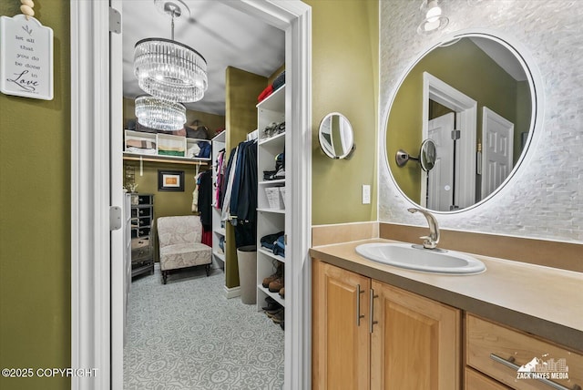 222 E 7th Ave # 106, Anchorage, AK 99501 - bathroom with an inviting chandelier, a walk in closet, and vanity