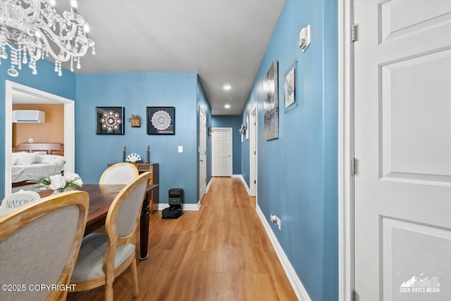 222 E 7th Ave # 106, Anchorage, AK 99501 - corridor with a chandelier, light wood-style flooring, recessed lighting, baseboards, and a wall unit AC