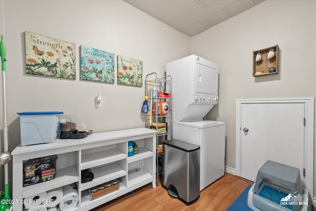 222 E 7th Ave # 106, Anchorage, AK 99501 - washroom with stacked washer / drying machine, light wood-style flooring, and laundry area