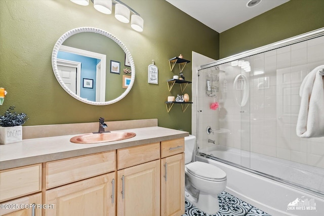 222 E 7th Ave # 106, Anchorage, AK 99501 - full bath featuring toilet, tile patterned floors, bath / shower combo with glass door, and vanity