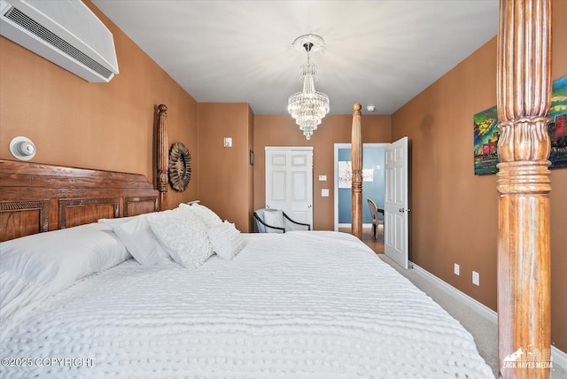 222 E 7th Ave # 106, Anchorage, AK 99501 - carpeted bedroom with baseboards, a wall mounted AC, and a notable chandelier