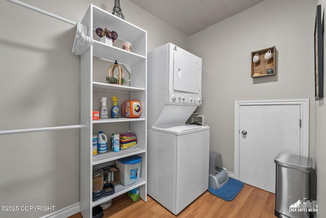 222 E 7th Ave # 106, Anchorage, AK 99501 - laundry room featuring stacked washer / drying machine and light wood-style floors