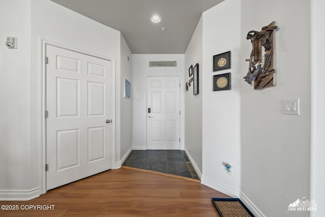 222 E 7th Ave # 106, Anchorage, AK 99501 - hallway with baseboards and dark wood-style flooring