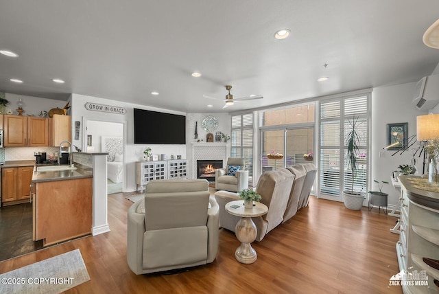 222 E 7th Ave # 106, Anchorage, AK 99501 - living room with ceiling fan, dark wood-style floors, a fireplace, and recessed lighting