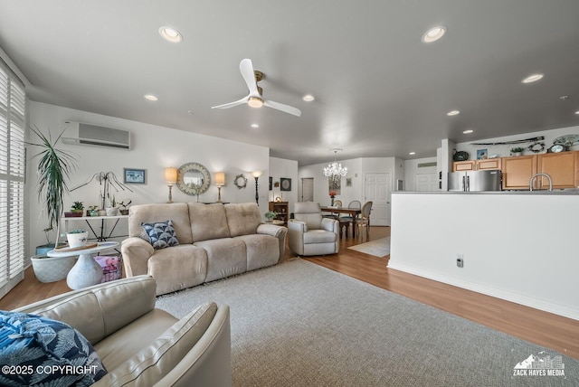 222 E 7th Ave # 106, Anchorage, AK 99501 - living room with an AC wall unit, wood finished floors, a chandelier, ceiling fan, and recessed lighting