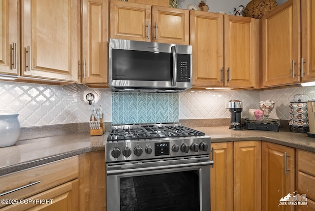 222 E 7th Ave # 106, Anchorage, AK 99501 - kitchen featuring stainless steel appliances, tasteful backsplash, and dark countertops
