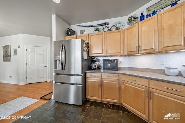 222 E 7th Ave # 106, Anchorage, AK 99501 - kitchen featuring stainless steel refrigerator with ice dispenser and decorative backsplash