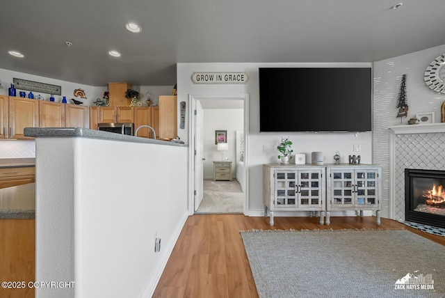 222 E 7th Ave # 106, Anchorage, AK 99501 - living area featuring light wood finished floors, a fireplace, and recessed lighting