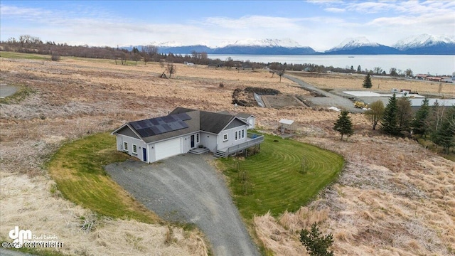 aerial view featuring a water and mountain view